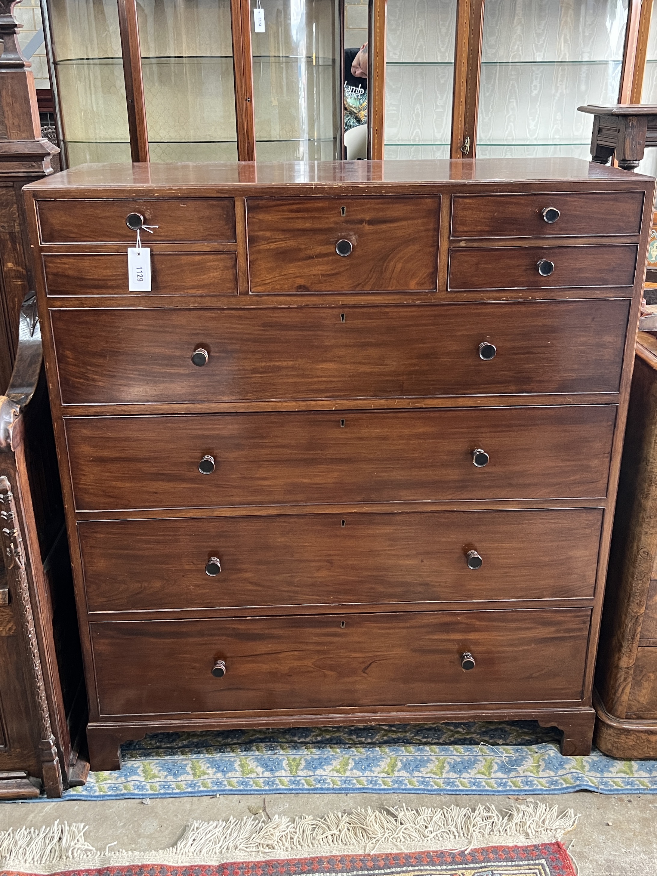 An early 20th century Heal and Son mahogany nine drawer chest, bears circular ivorine plaque, width 96cm, depth 53cm, height 104cm